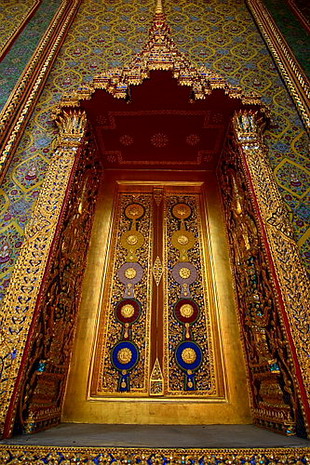 “บานหน้าต่างพระวิหาร”  สลักด้วยไม้เป็นลวดลายไทยจำลองรูปดวงตราเครื่องราชอิสริยาภรณ์