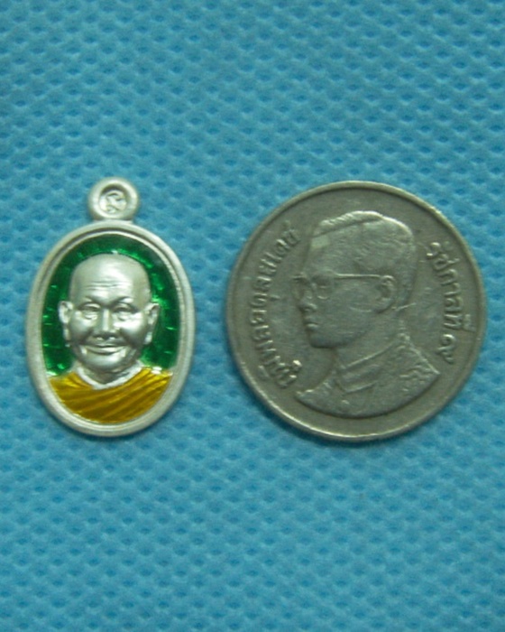 เหรียญเม็ดแตงหลวงพ่อจรัญ รุ่นโภคทรัพย์ เนื้อเงินลงยาราชาวดี สีเขียว หลังราชสีห์ หมายเลข ๖๐๗