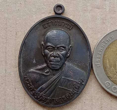 เหรียญสร้างบารมี หลวงพ่อสิน วัดละหารใหญ่ จ.ระยอง ปี2557 เนื้อทองแดงรมดำ หมายเลข3450+กล่อง